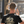 Load image into Gallery viewer, Back view of black Badges T-Shirt by Vintage Vices, male model, headphones
